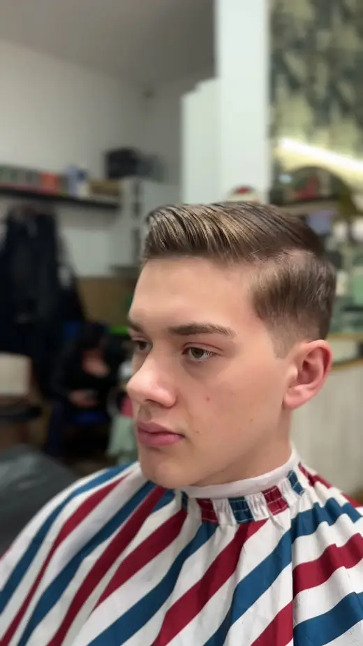 Corte clásico con raya y degradado lateral · Barbería Los Primos Tarik, Getafe